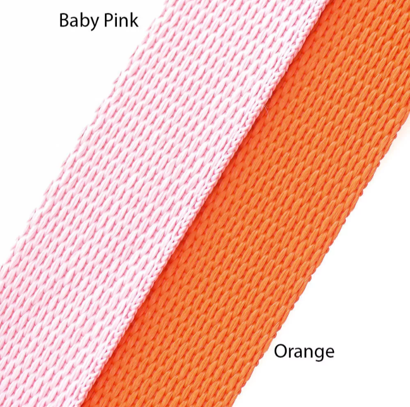 Close-up of baby pink and orange fabric swatches.