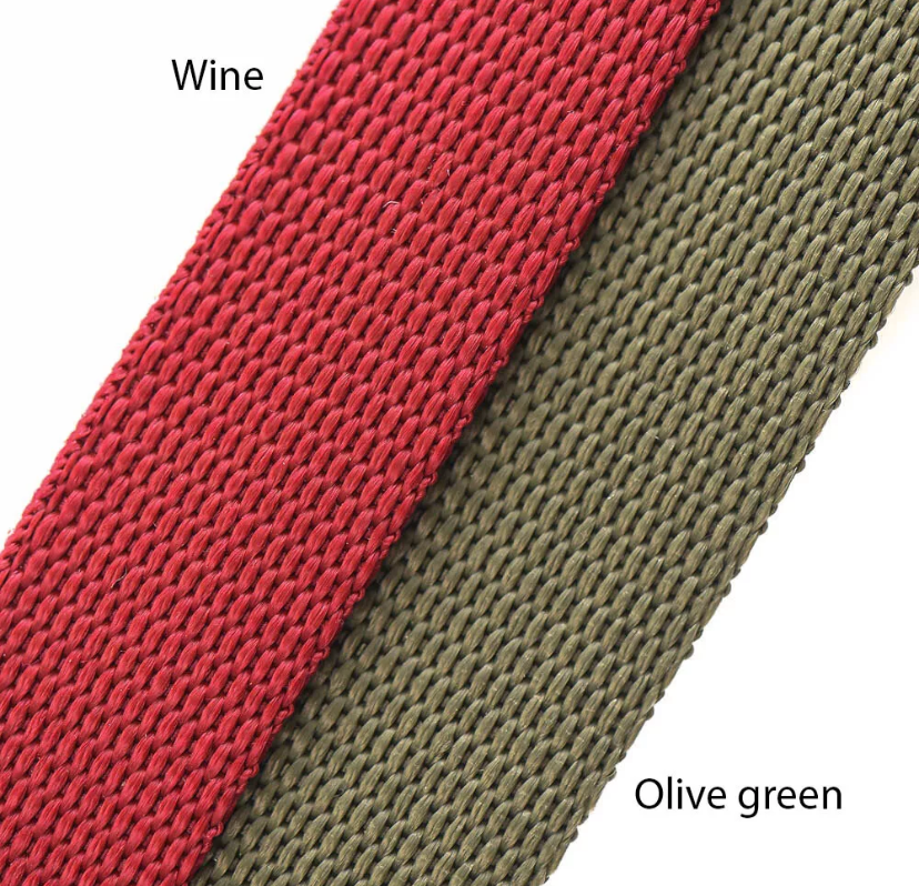 Two woven straps, one red and one olive green, on a white background.